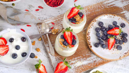 Fresh yogurt and berries for a healthy breakfast. Flat layの写真素材