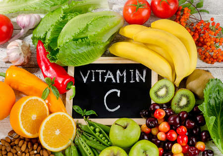 Foods High in vitamin C on wooden board.  Healthy eating. Flat layの写真素材