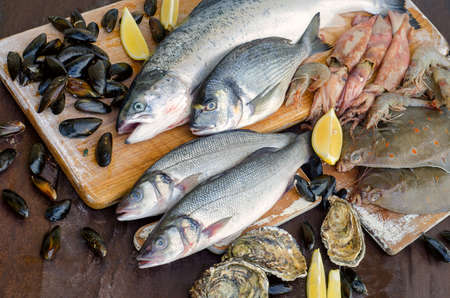 Seafood with fresh herbs. Healthy food. Top viewの写真素材