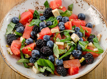 Watermelon Salad with cheese and berries. Healthy eating.の写真素材
