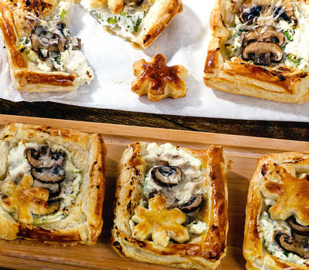 Puff pastry Mushroom tarts on a wooden board.の写真素材