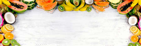 Exotic tropical fruits mix on white wooden background. Healthy eating concept.の写真素材