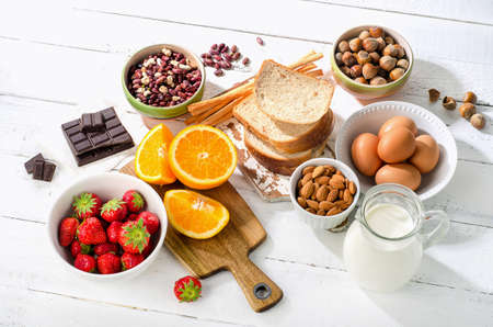 Allergy food concept. Allergic food on white wooden backgroundの写真素材