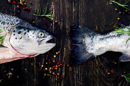Fresh salmon on  dark rustic table. Flat lay. Healthy food  concept.の写真素材