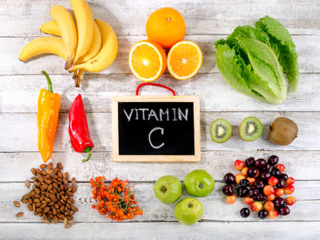 Foods High in vitamin C on  wooden background.  Healthy eating. Flat layの写真素材