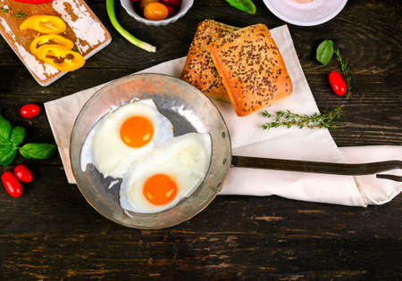 Fried eggs on a wooden table for Healthy breakfast. Flat lay