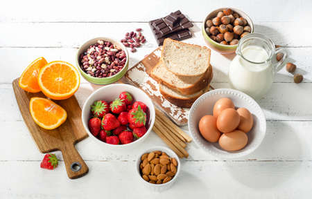 Allergy food concept. Allergic food on a white wooden background. Top viewの写真素材