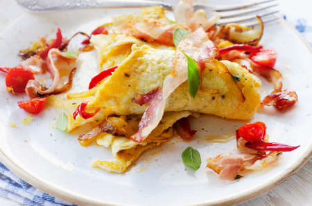 Omelet with bacon and vegetables for a healthy breakfast . Selective focusの写真素材