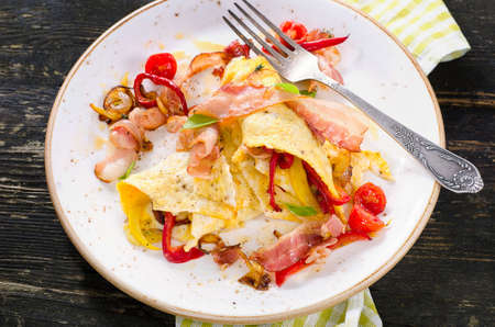 Eggs, bacon and vegetables for healthy breakfast on dark wooden table. Top viewの写真素材