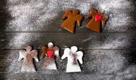 Christmas Gingerbread Angels on a rustic wooden background. Top view