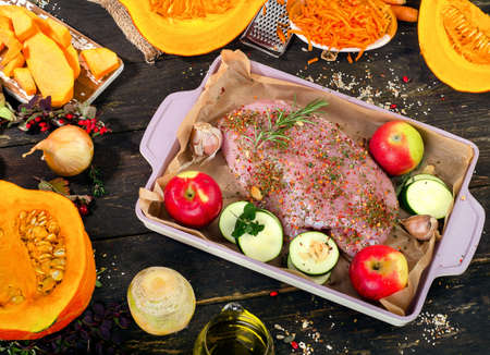 Raw Turkey breast and fresh vegetables  on  dark wooden board. Top viewの写真素材