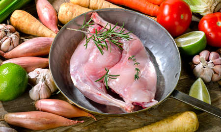 Raw rabbit legs in a vintage pan.の写真素材