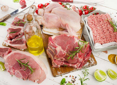 Different types of raw meat with fresh vegetables and spices.  View from aboveの写真素材