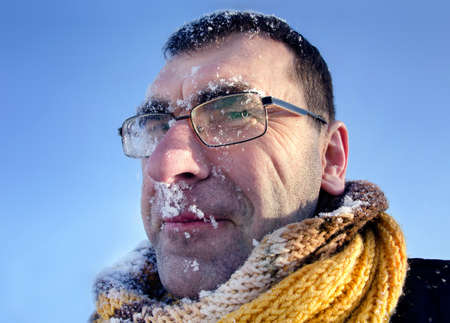 Happy Man in snow. Face closeup