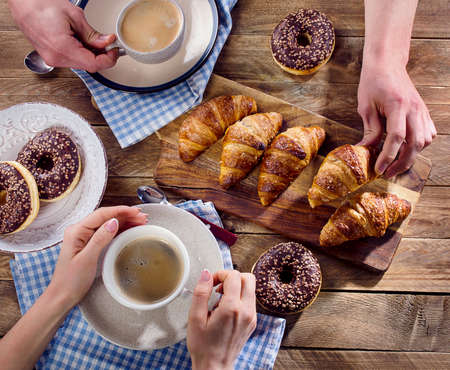Breakfast. Hands holding cups of coffee. Flat layの写真素材