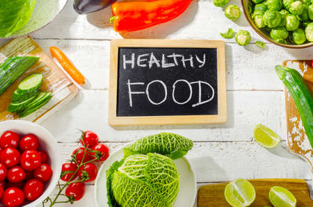 Healthy organic vegetables  on white wooden background. Top view. Diet eating