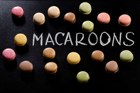 Colorful macaroons on black background. Top viewの写真素材