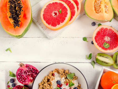 Fresh fruits on white wooden table. Healthy diet eating concept. Flat lay