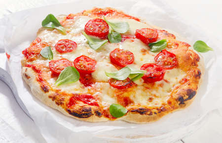 Pizza on white wooden background.の写真素材