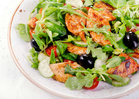 Healthy salad with chicken, arugula, cucumber  and tomato. Top viewの写真素材