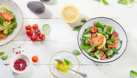 Fresh Salmon salad on a white wooden table. Healthy diet eating. View from above