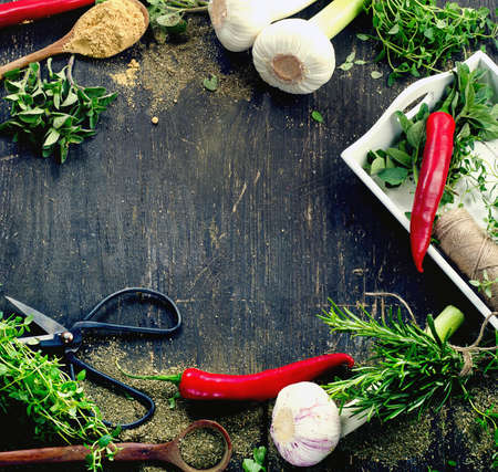 Fresh herbs and  spices on a rustic wooden table