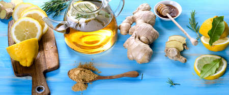 Tea with lemon and ginger on a wooden background.