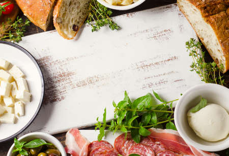 Various types of italian food on a wooden board. View from aboveの写真素材