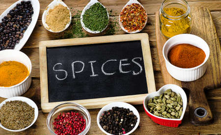 Various colorful spices on a wooden table. Top viewの写真素材