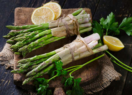 Fresh green asparagus on rustic wooden board.の写真素材