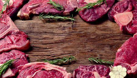 Raw meat on a dark wooden board. Food high in proteinの写真素材