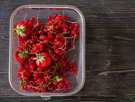 Mix of fresh berries on wooden board. Healthy eating conceptの写真素材