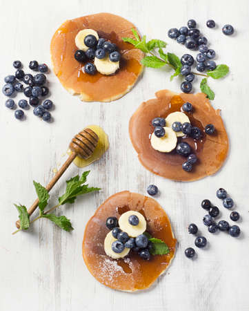 Pancakes with fresh fruits and honeyの写真素材