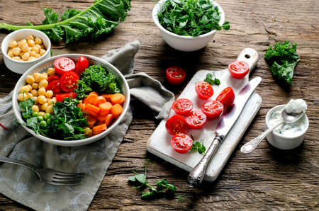Vegetarian Buddha bowl with tomatoes, chickpeas and carrots. Healthy eating and vegetarian food conceptの写真素材