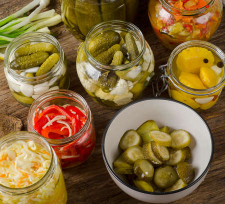 Fermented preserved vegetables on a dark rustic table.の写真素材