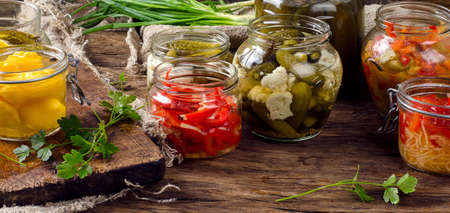 Fermented preserved vegetables on a dark rustic table.の写真素材