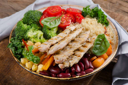 Healthy bowl with grilled chicken, quinoa, chickpea, kale, broccoliの写真素材