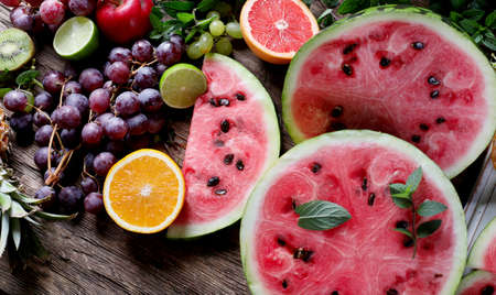 Slices of watermelon with fruits on wooden  background. Top view