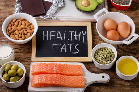 Selection of healthy fat sources on wooden background. Top viewの写真素材