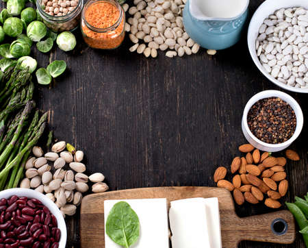 Organic Vegetables and legumes for healthy cooking on dark rustic background. Top viewの写真素材