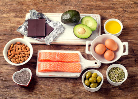 Selection of healthy fat sources on wooden background. Top viewの写真素材