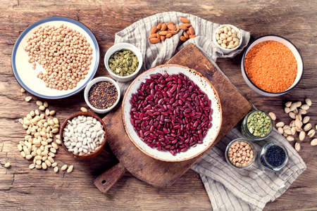 Various dry legumes on a wooden background. Top viewの写真素材