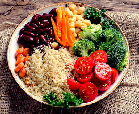 Healthy vegetables bowl with  quinoa, chickpea, kale, broccoli and tomatoes