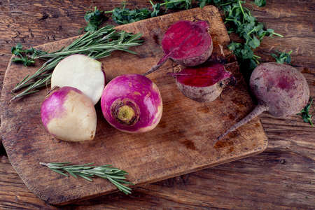 Fresh turnips  and beetroot on rustic wooden board. Organic foods.  Top view