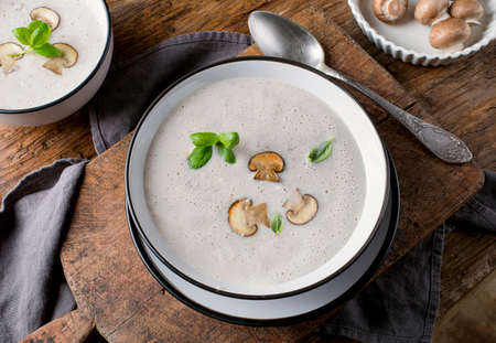 Creamy Mushroom Soup on rustic wooden table/ View from aboveの写真素材