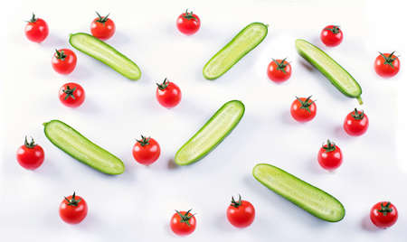 Cherry tomatoes and cucumbers pattern on a white background. Flat layの写真素材