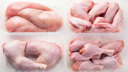 Different types of raw chicken meat in plastic boxesの写真素材