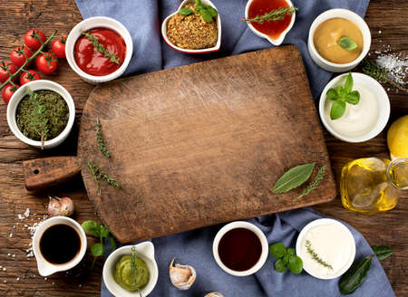 Bowls of various sauces on wooden background.  Top viewの写真素材