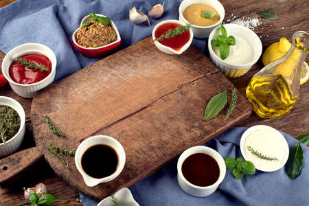 Bowls of various sauces on wooden background.  Top viewの写真素材