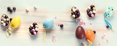 Spring flowers with easter eggs on a blue wooden background